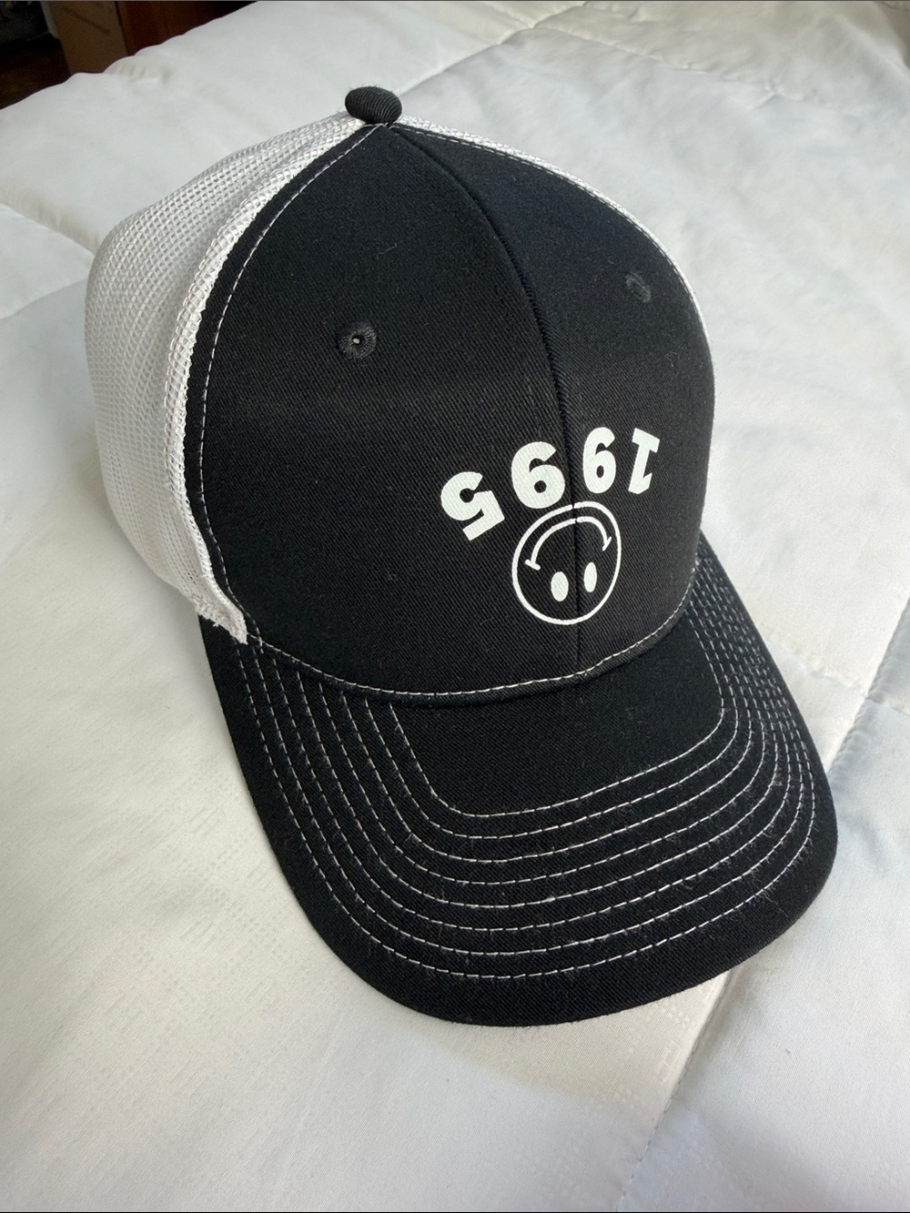 Black & White Trucker Hat with Upside Down 1995 Smile Graphic